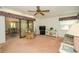 Cozy living room with sliding glass doors, comfortable seating, and a ceiling fan provides relaxed living at 34507 Cedarfield Dr, Dade City, FL 33523