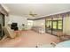 Bright living room with sliding glass doors, comfortable sofa, and ceiling fan provides relaxed living at 34507 Cedarfield Dr, Dade City, FL 33523