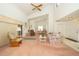 Expansive living room with vaulted ceiling, fireplace, carpeted floors and view to dining area at 34507 Cedarfield Dr, Dade City, FL 33523
