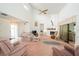 Bright living room with vaulted ceilings, a white brick fireplace, and comfortable seating arrangement at 34507 Cedarfield Dr, Dade City, FL 33523