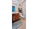 Traditional bathroom featuring a wood vanity, white toilet, patterned shower curtain, and soft gray rug at 3505 Tarpon Woods Blvd # I407, Palm Harbor, FL 34685