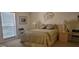 Comfortable bedroom with neutral decor, lamps, and a window with blinds at 3505 Tarpon Woods Blvd # I407, Palm Harbor, FL 34685