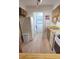 Bright kitchen featuring wood cabinets, white appliances, and laminate wood flooring at 3505 Tarpon Woods Blvd # I407, Palm Harbor, FL 34685