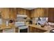 Kitchen featuring wooden cabinets, white appliances and laminate countertops at 3505 Tarpon Woods Blvd # I407, Palm Harbor, FL 34685