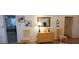 Cozy living room space with access to bedroom; features seating and decorative mirror at 3505 Tarpon Woods Blvd # I407, Palm Harbor, FL 34685