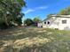 View of the expansive backyard, offering ample space for outdoor activities and potential landscaping projects at 403 E Carolina Ave, Plant City, FL 33563