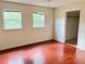 A bedroom with two windows and updated flooring at 403 E Carolina Ave, Plant City, FL 33563