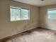 A bedroom with two windows letting in natural light at 403 E Carolina Ave, Plant City, FL 33563