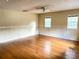 Large bedroom with two windows and hardwood floors bathed in natural light at 403 E Carolina Ave, Plant City, FL 33563