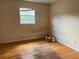 A room with hard wood flooring and one window at 403 E Carolina Ave, Plant City, FL 33563