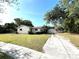Charming single-story home featuring a detached garage and a long driveway at 403 E Carolina Ave, Plant City, FL 33563