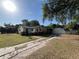 Charming single-story home featuring a detached garage and a long driveway at 403 E Carolina Ave, Plant City, FL 33563