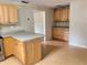 Kitchen featuring wood cabinets and a peninsula with laminate countertops at 403 E Carolina Ave, Plant City, FL 33563