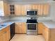 Kitchen featuring stainless steel appliances, wood cabinets, and laminate countertops at 403 E Carolina Ave, Plant City, FL 33563