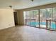 Living room with tile floors and a view of the screened-in pool area at 403 E Carolina Ave, Plant City, FL 33563