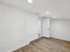 Open basement features wood-look floors, recessed lighting, and an open doorway at 4215 E Paris St, Tampa, FL 33610