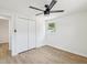 Bright bedroom features a ceiling fan, wood floors, a window, and a closet at 4215 E Paris St, Tampa, FL 33610
