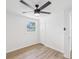 Bright bedroom features wood floors, a window, closet, and ceiling fan at 4215 E Paris St, Tampa, FL 33610