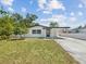 Charming home featuring well-maintained lawn, inviting entrance, and convenient carport at 4215 E Paris St, Tampa, FL 33610