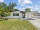 Charming single-story home featuring a covered carport, freshly painted exterior, and well-maintained landscaping at 4215 E Paris St, Tampa, FL 33610