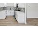 Beautifully renovated kitchen with white cabinets, modern appliances, and updated backsplash at 4215 E Paris St, Tampa, FL 33610