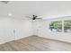 Bright and airy living room with new laminate floors and natural light at 4215 E Paris St, Tampa, FL 33610