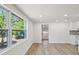 Open-concept living room with wood floors, recessed lighting, and bright windows at 4215 E Paris St, Tampa, FL 33610