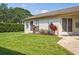 Well-kept backyard featuring lush lawn, mature trees, and partial view of the home's exterior at 4655 Wallingford Ct # 4655, New Port Richey, FL 34655