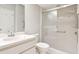 Well-lit bathroom with tiled shower and glass door, featuring a sink with a modern faucet at 4655 Wallingford Ct # 4655, New Port Richey, FL 34655
