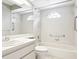 Well-maintained bathroom with a tub, shower, and modern fixtures, highlighted by a round window at 4655 Wallingford Ct # 4655, New Port Richey, FL 34655