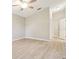 Spacious bedroom with light-colored walls, wood-look flooring, ceiling fan, and closet at 4655 Wallingford Ct # 4655, New Port Richey, FL 34655