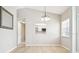 Dining area shows a window into the kitchen, neutral walls, and light wood flooring at 4655 Wallingford Ct # 4655, New Port Richey, FL 34655