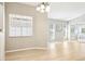 Dining room with light wood floors, neutral walls, modern chandelier, and an abundance of natural light at 4655 Wallingford Ct # 4655, New Port Richey, FL 34655