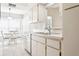 Bright kitchen featuring white cabinetry, stainless steel dishwasher, and adjacent dining area at 4655 Wallingford Ct # 4655, New Port Richey, FL 34655
