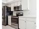Modern kitchen featuring stainless steel appliances, white cabinetry, and ample counter space at 4655 Wallingford Ct # 4655, New Port Richey, FL 34655