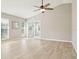 Bright and airy living room with vaulted ceiling, light wood flooring, and French doors to another room at 4655 Wallingford Ct # 4655, New Port Richey, FL 34655