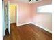 Bedroom with hardwood floors, closet and window at 4811 Haines N Rd, St Petersburg, FL 33714