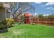 Spacious backyard with a well-maintained lawn and a fun wooden playset for  at 4913 N Central Ave, Tampa, FL 33603