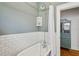 Bathroom featuring a classic clawfoot tub with shower and tiled walls at 4913 N Central Ave, Tampa, FL 33603