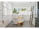 Bright bathroom featuring a freestanding tub, patterned tile floor, and a glass enclosed shower with a wooden ladder at 4913 N Central Ave, Tampa, FL 33603