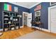 A blue room featuring a wooden floor and an open door at 4913 N Central Ave, Tampa, FL 33603