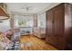 Sunlit bedroom with hardwood floors, two cribs, and charming decor at 4913 N Central Ave, Tampa, FL 33603
