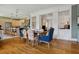 Open dining room with hardwood floors, colorful chairs, and partial view into the kitchen and living room at 4913 N Central Ave, Tampa, FL 33603