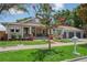 Charming home with a well-manicured lawn, brick accents, and a covered front porch with rocking chairs at 4913 N Central Ave, Tampa, FL 33603