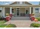 Inviting front porch with swing, brick accents, and decorative plants creating a cozy and welcoming entrance at 4913 N Central Ave, Tampa, FL 33603