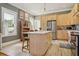 Bright kitchen with a center island, stainless steel appliances, natural wood cabinets and modern countertops at 4913 N Central Ave, Tampa, FL 33603