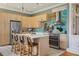 Charming kitchen featuring stainless steel appliances, a tiled backsplash, and a cozy breakfast bar seating at 4913 N Central Ave, Tampa, FL 33603