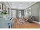 Cozy living room with a vintage piano, eclectic decor, hardwood floors, and neutral paint at 4913 N Central Ave, Tampa, FL 33603