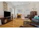 Cozy living room featuring a fireplace, hardwood floors, and comfortable seating at 4913 N Central Ave, Tampa, FL 33603