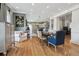Open concept living and dining area featuring hardwood floors, neutral paint, and modern lighting at 4913 N Central Ave, Tampa, FL 33603